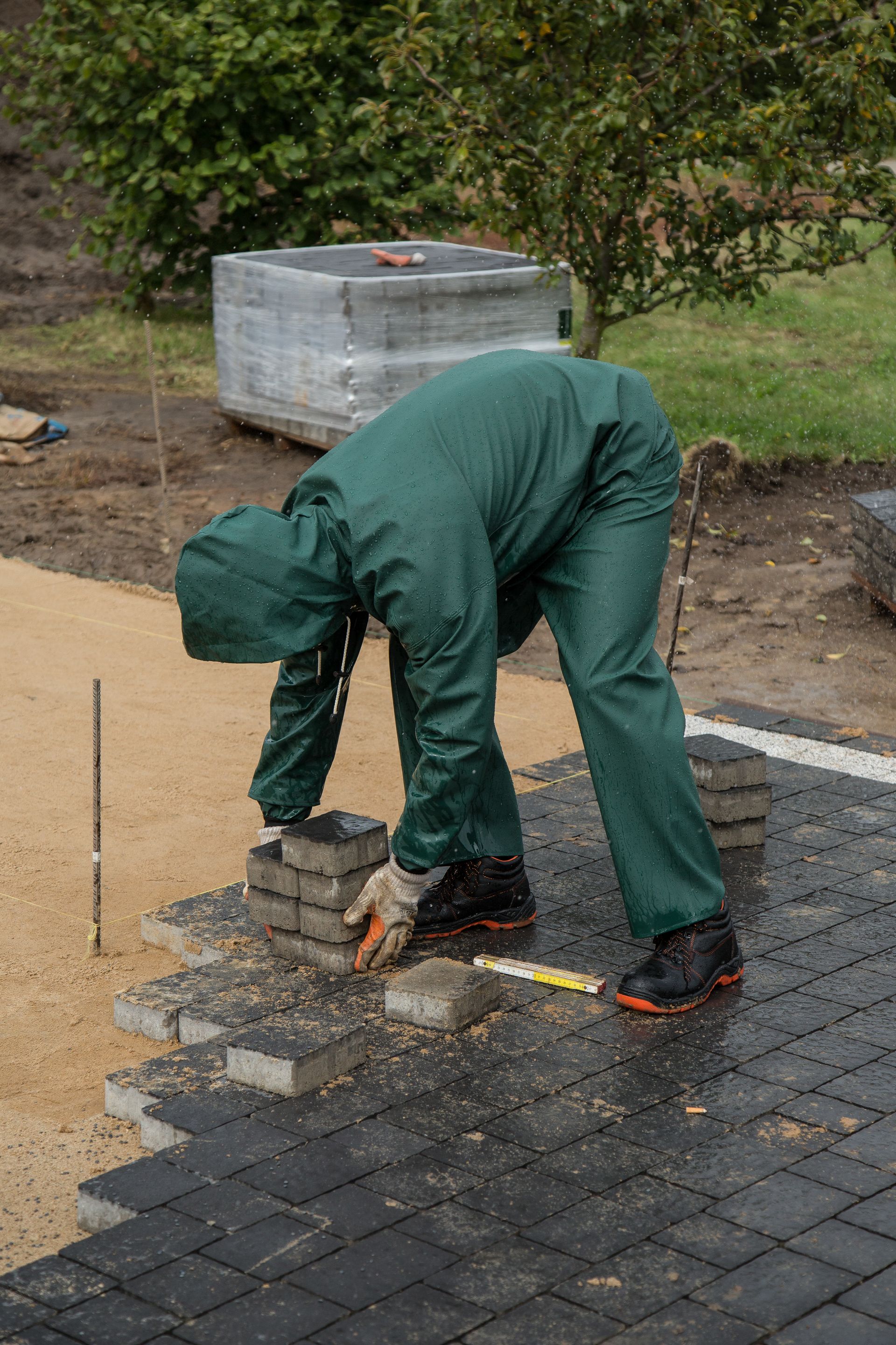 Vakman legt klinkers op een voorbereide ondergrond